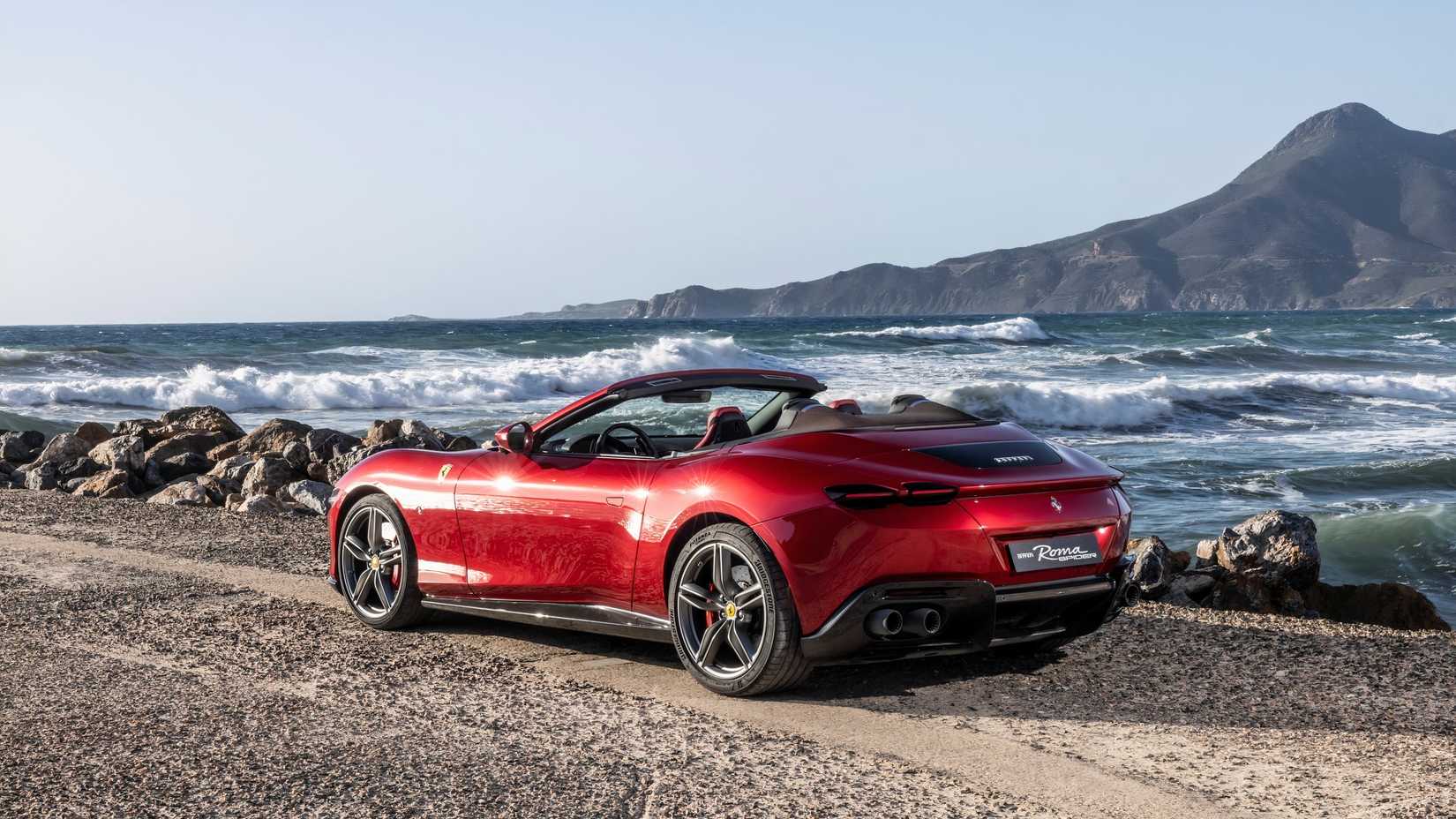 2024 Ferrari Roma Spider Rear shot parked by beach