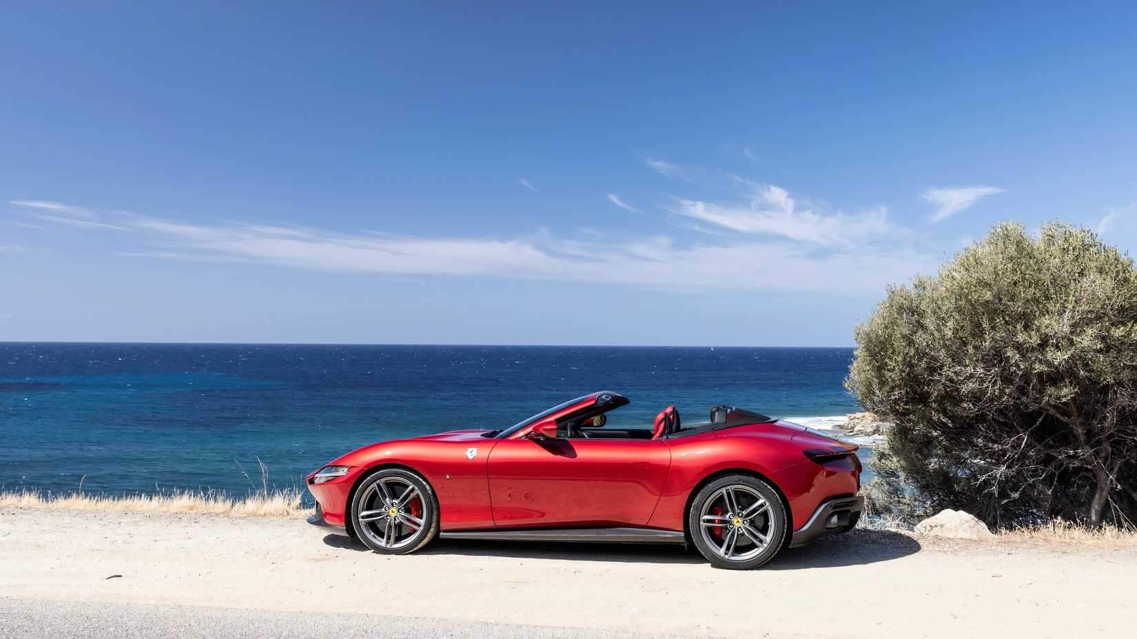 Side shot of a 2024 Ferrari Roma Spider parked by the beach