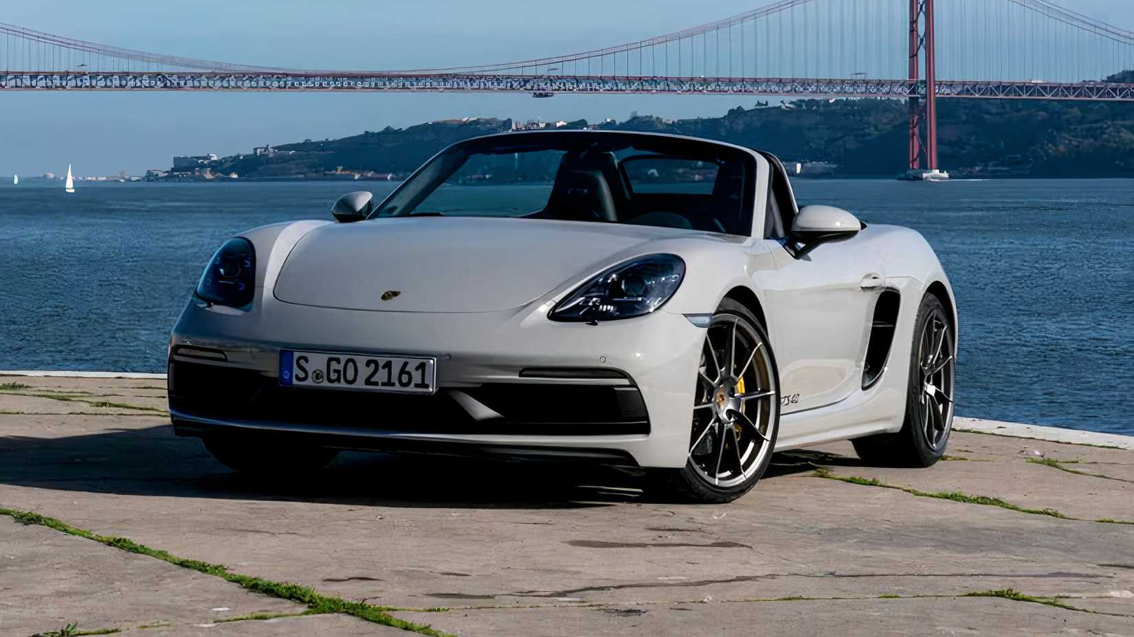 2024 Porsche 718 Boxster GTS 4.0 in gray Posing in front of water-side and in front of bridge