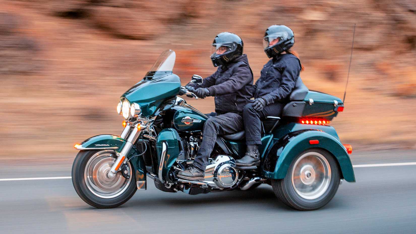Rider and passenger on a Harley-Davidson Tri Glide Ultra