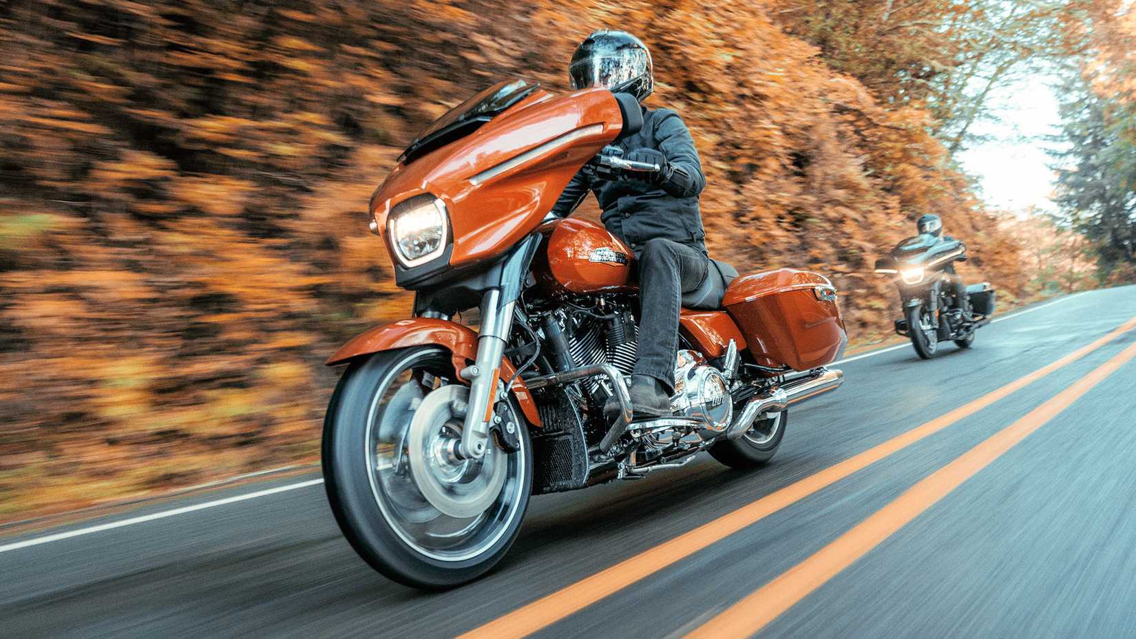 Two 2024 Harley-Davidson Street Glides cruising through the countryside