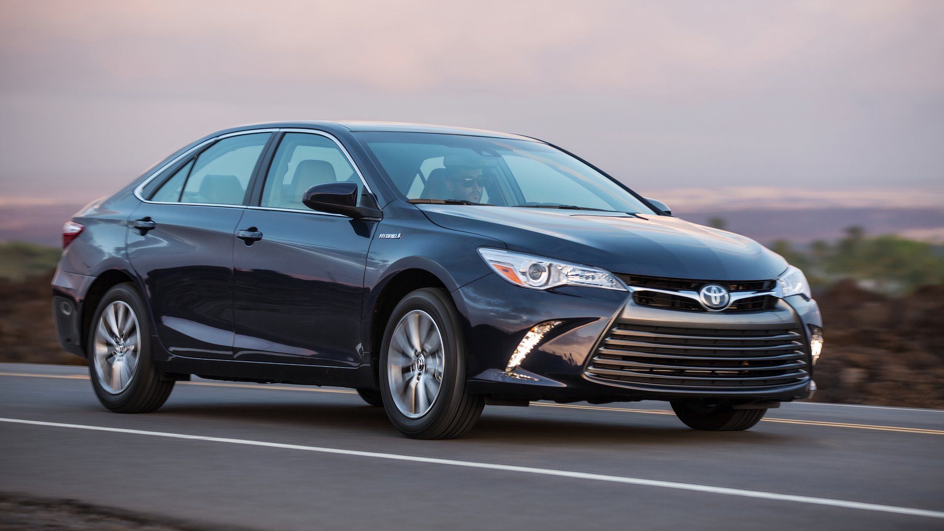 2015 Toyota Camry Hybrid front 3/4 rolling shot