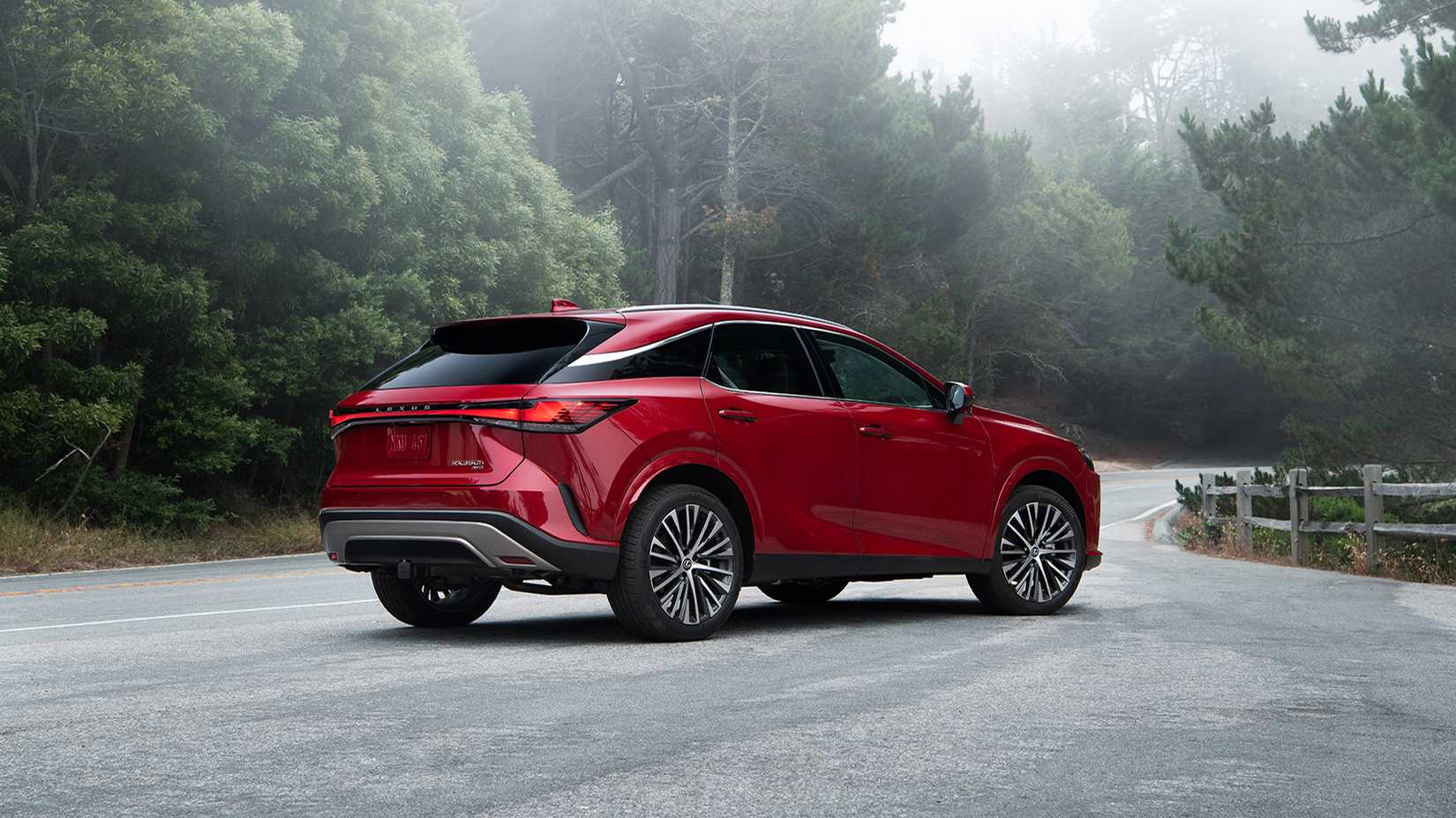A Red 2023 Lexus RX 350h rear 3/4 shot parked on the road