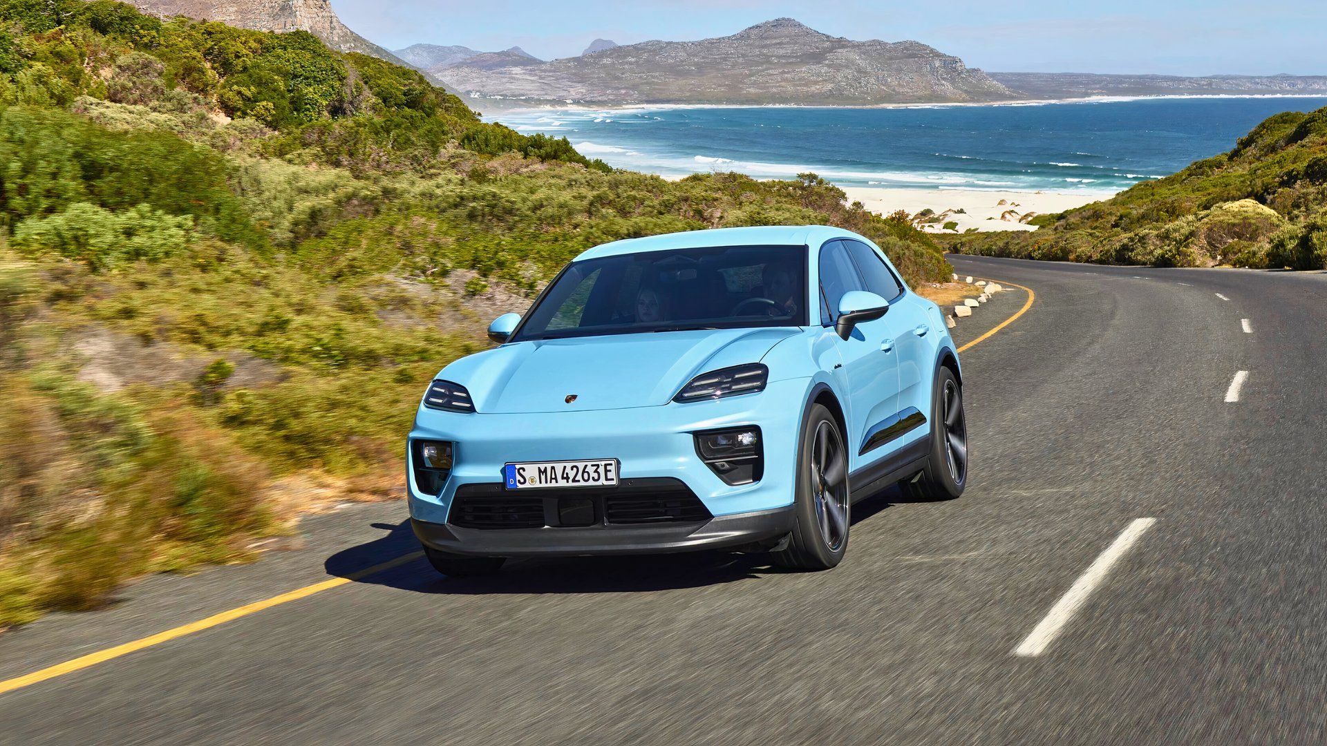 Front three-quarters shot of a blue 2025 Porsche Macan Electric 
