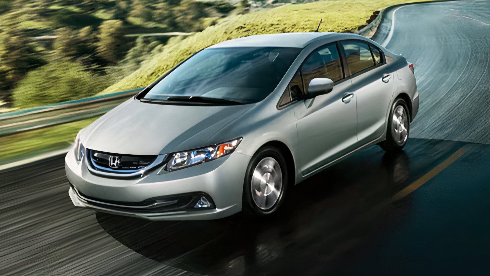 2009 Honda Civic Hybrid Sedan in silver Driving on country road