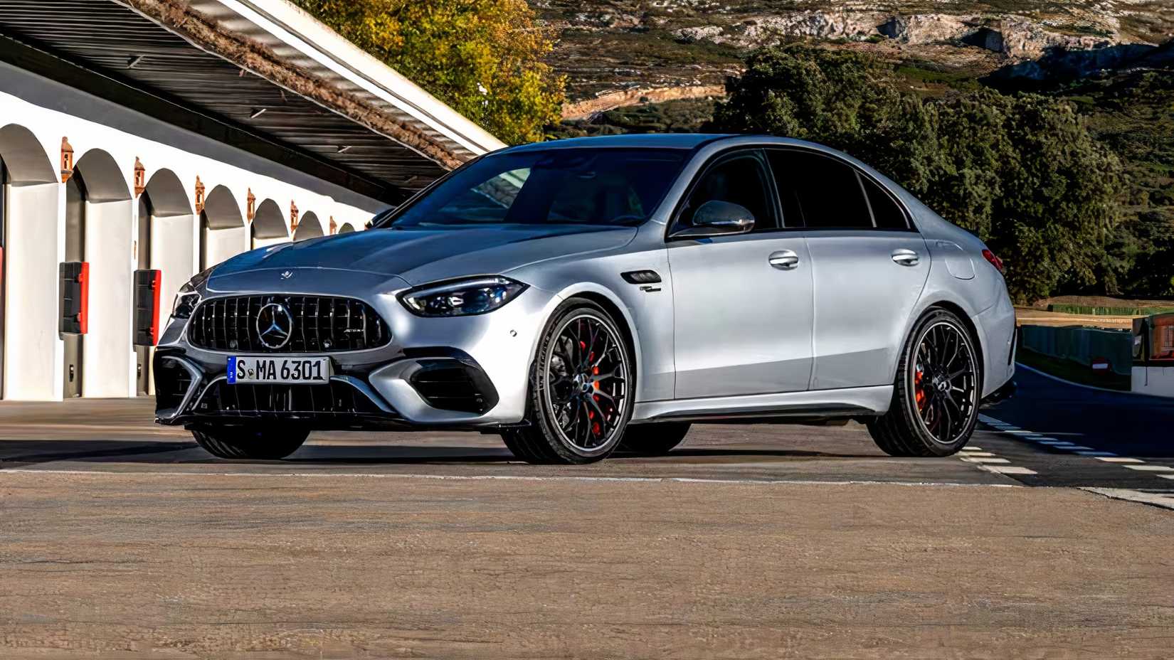 Mercedes-Benz C-Class AMG C 63 SE Performance Sedan in silver Posing in front of railway bridge