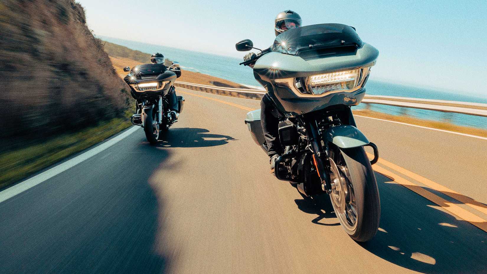 Riders on 2024 Harley-Davidson Road Glides coming out of a curve