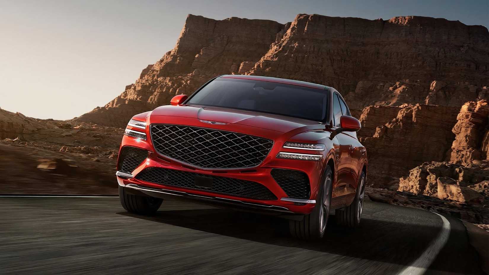 2025 Genesis GV80 Coupe in red driving on mountain road