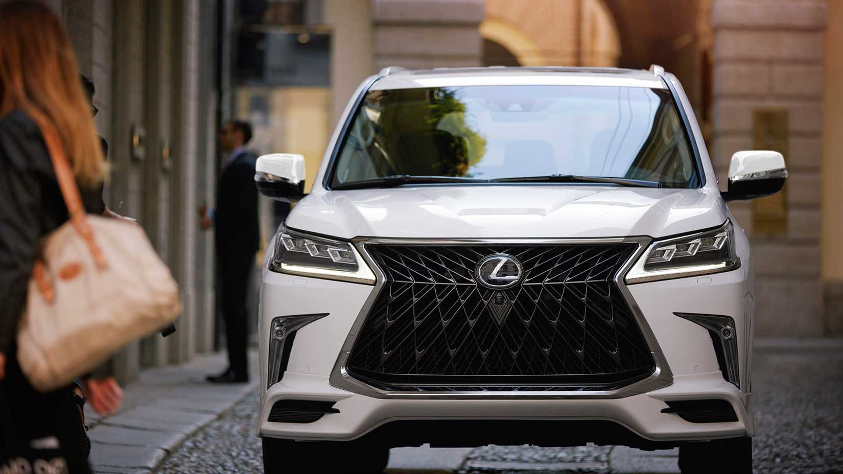 A 2020 Lexus LX 570 driving through a narrow street