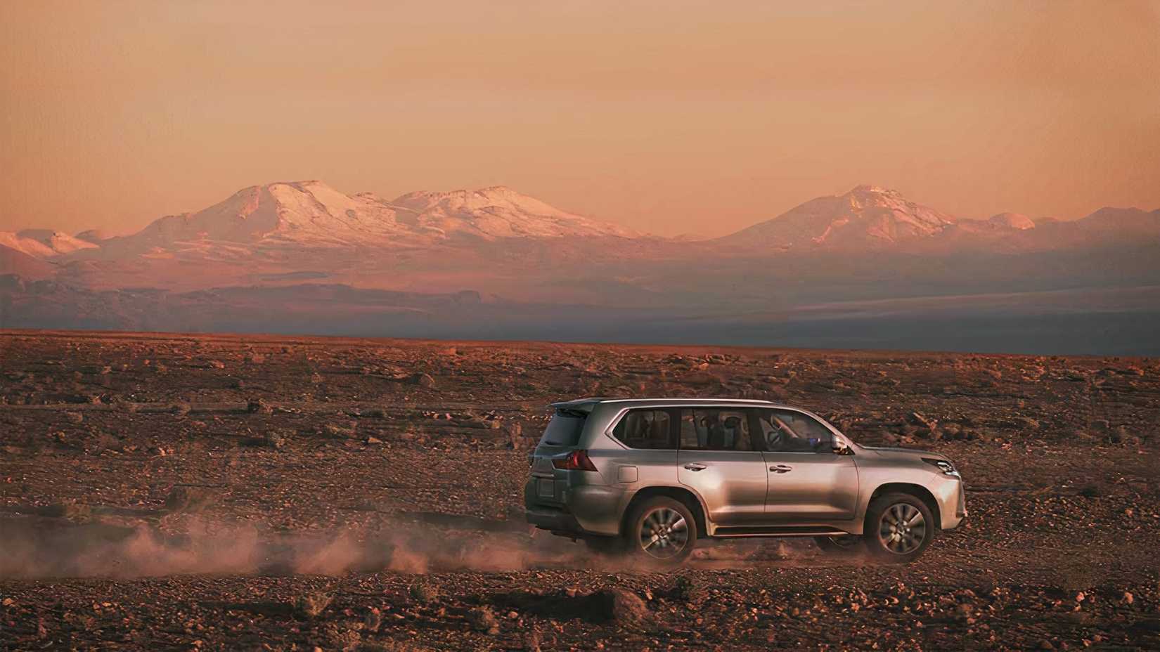 Side shot of a 2021 Lexus LX 570 off-roading in the desert