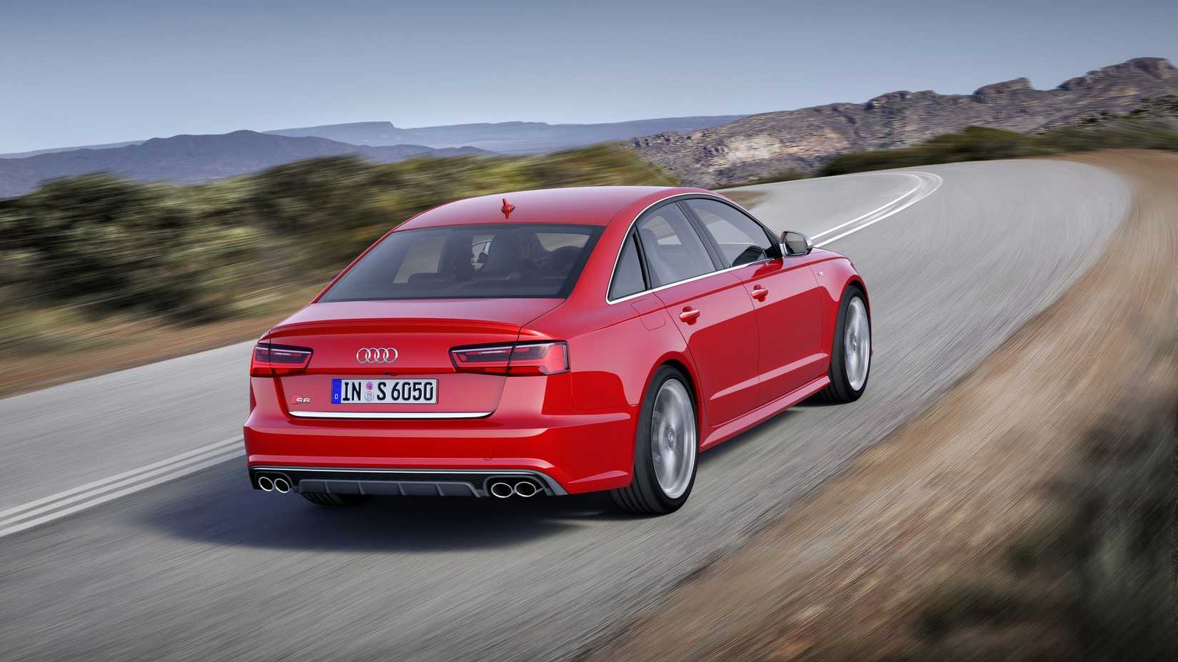 A rear view of the Audi S6 driving down a road