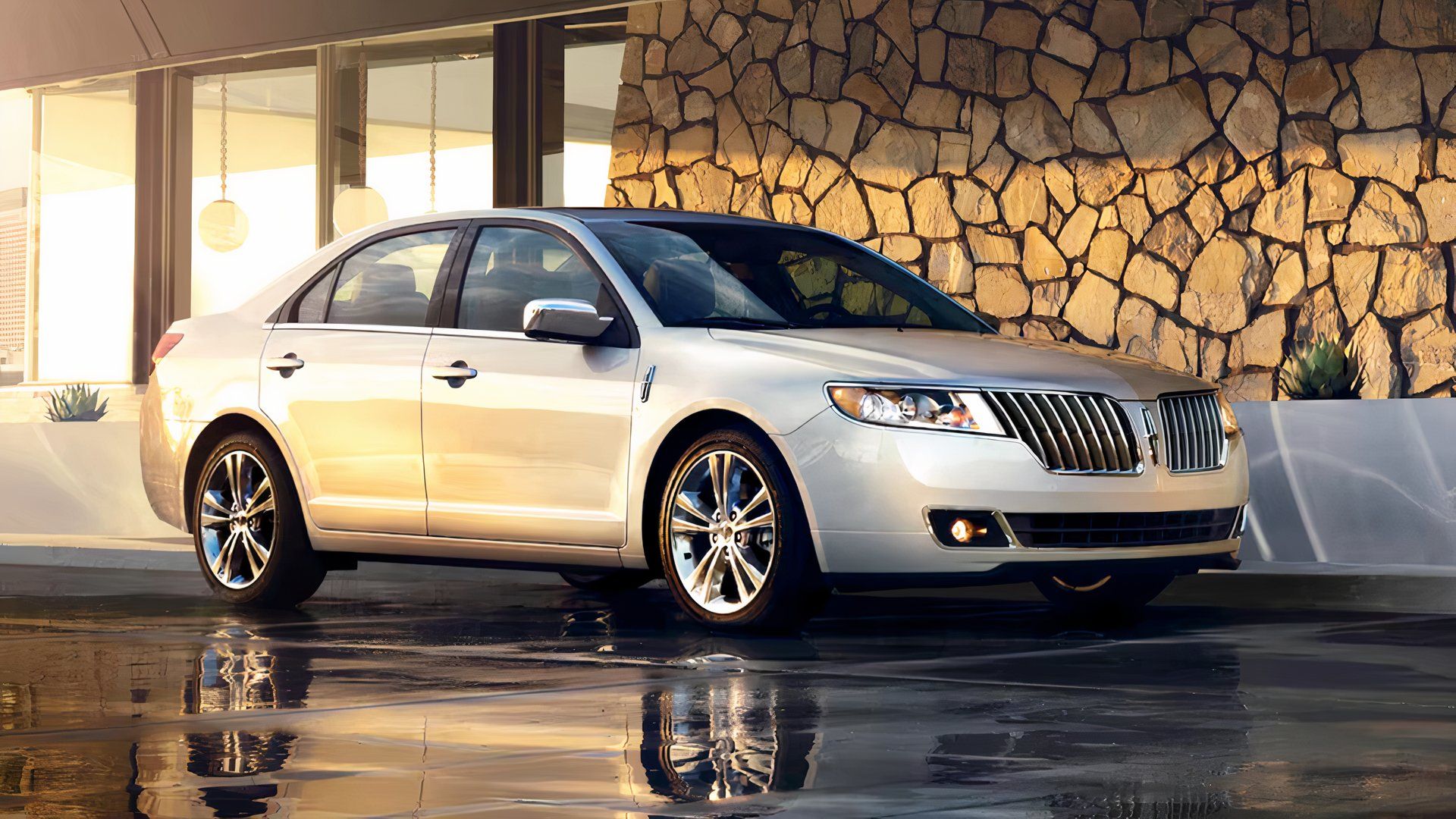 2012 Lincoln MKZ in silver posing on driveway of modern house