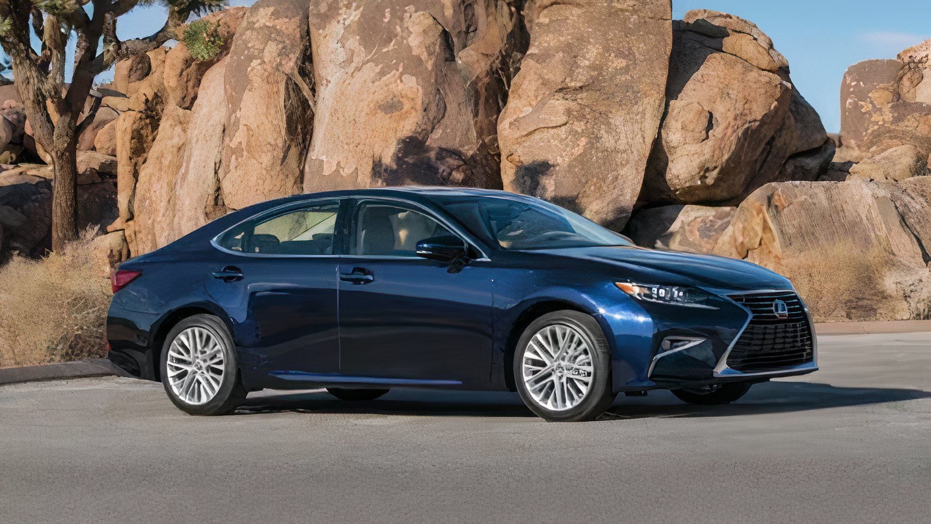 2018 Lexus ES in blue posing in front of rocks 