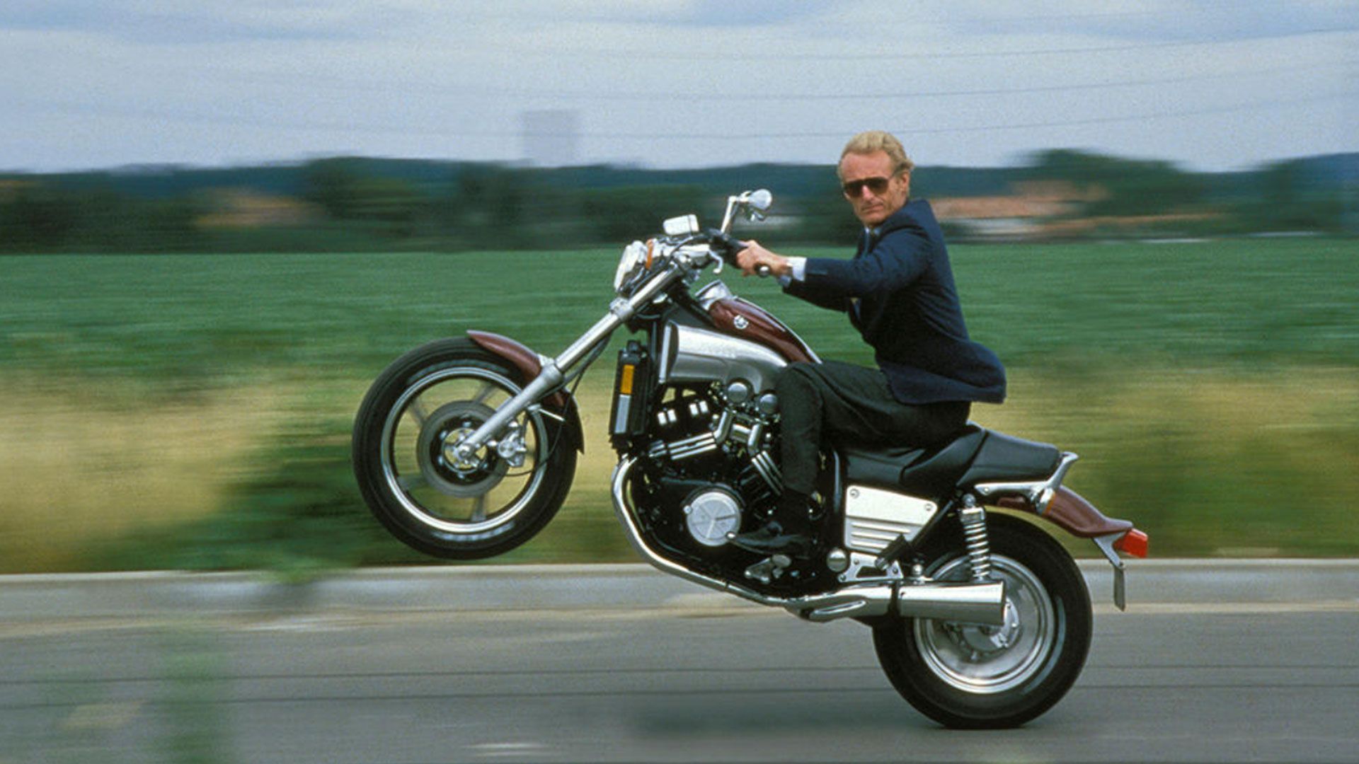 Director of Yamaha France, Jean-Claude Olivier popping a wheelie on 1985 Yamaha VMAX.