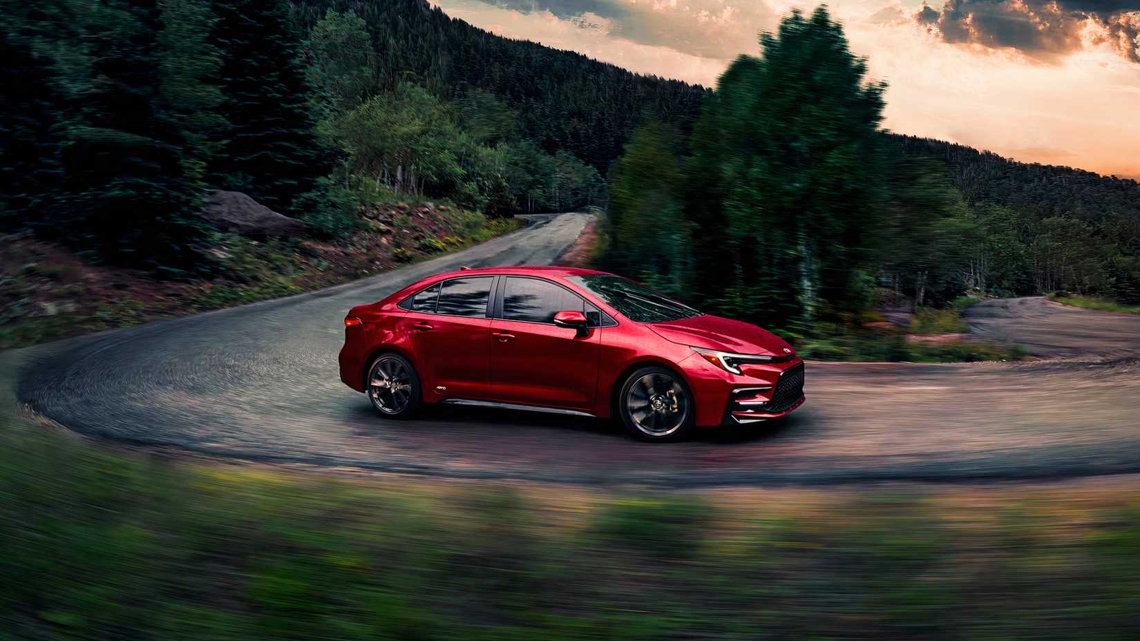 A red Toyota Corolla Hybrid is driving. 