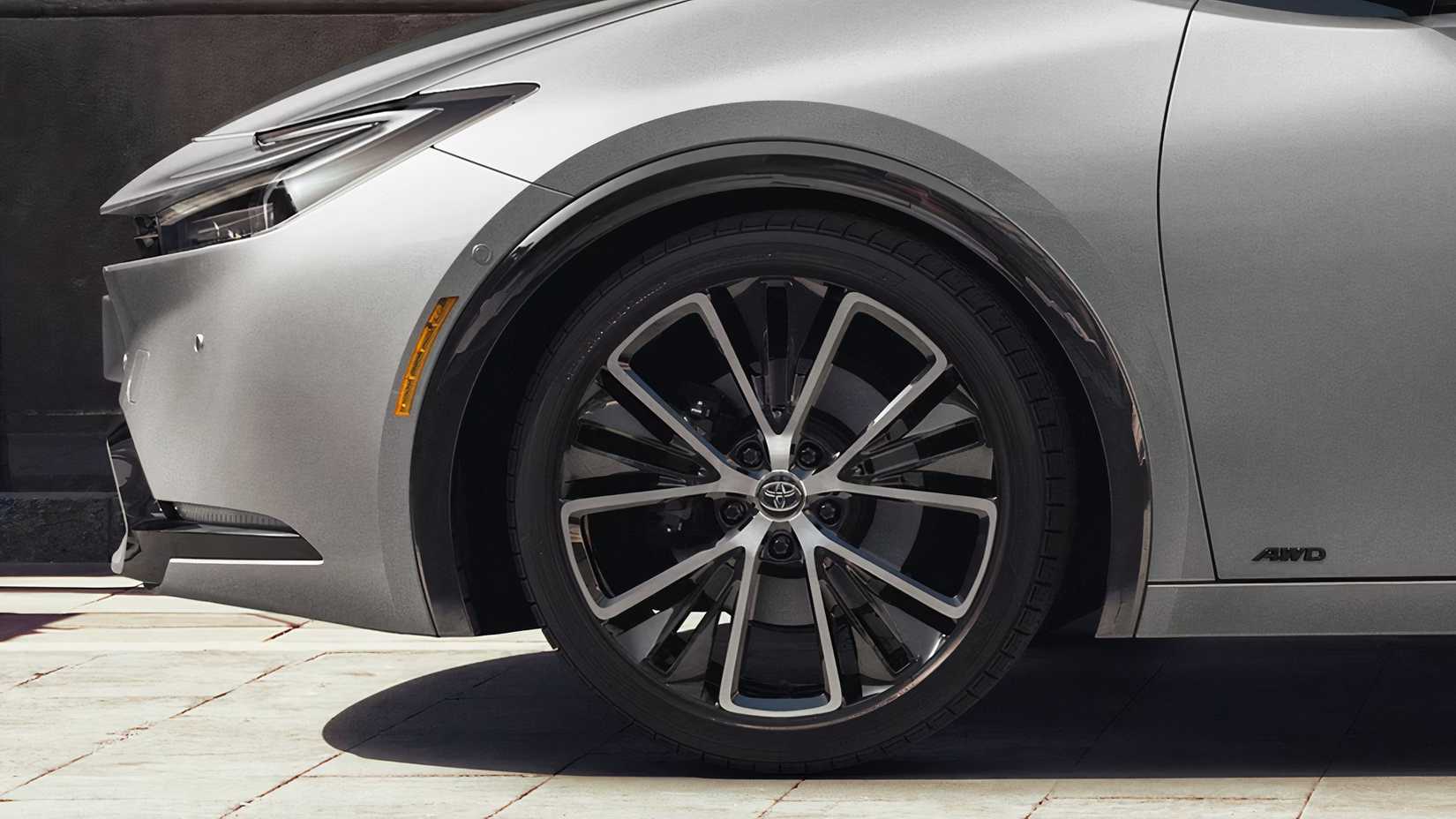 A gray Toyota Prius and its wheel.