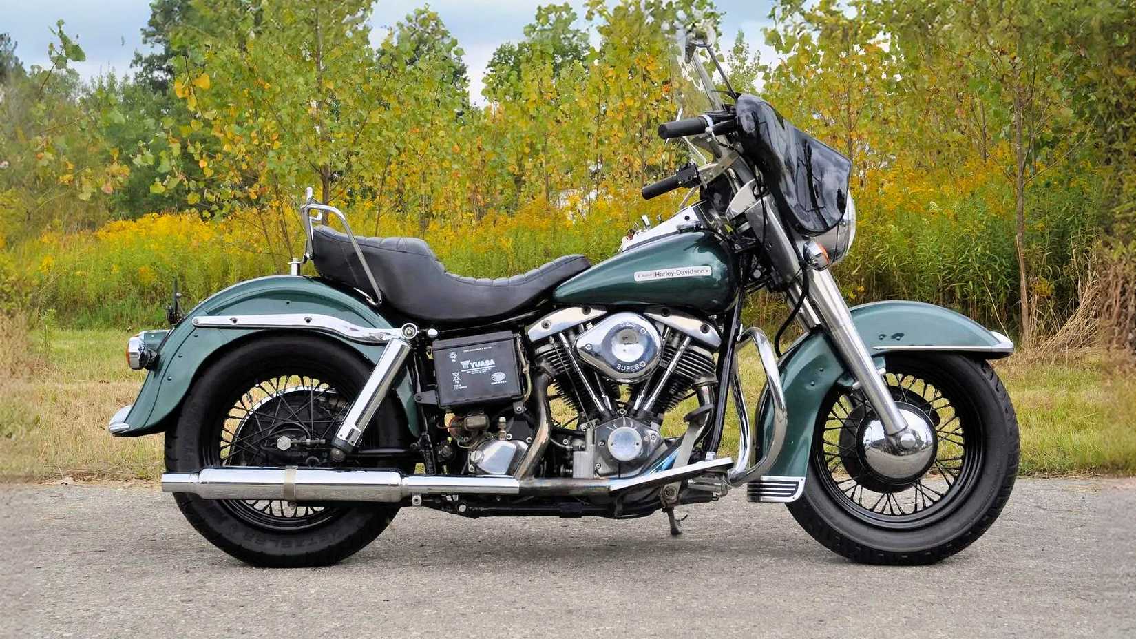 Foto de perfil estático da Harley-Davidson FLH Shovelhead 1972 estacionada na beira da estrada