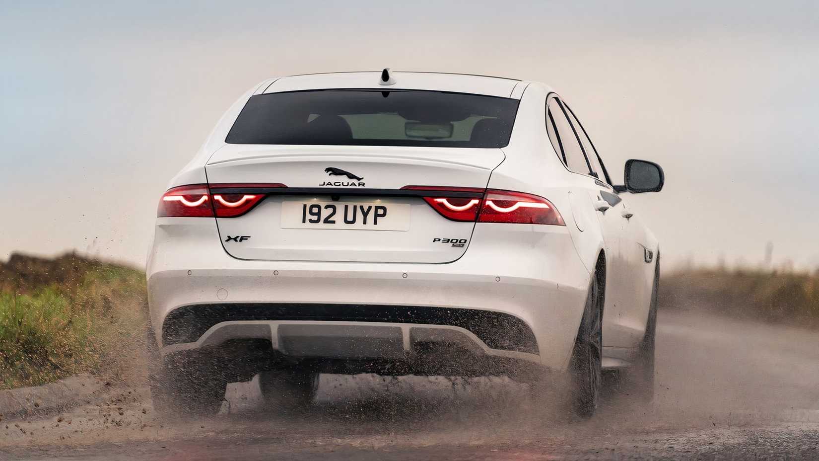 2023 Jaguar XF rear shot driving through dirt
