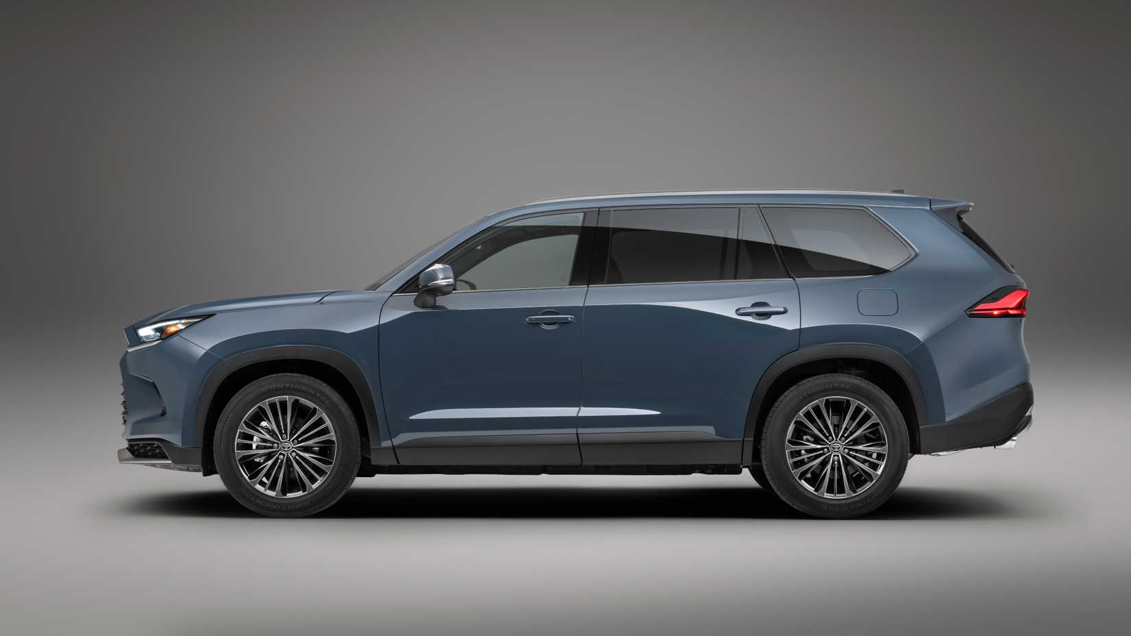 Side profile studio shot of the 2024 Toyota Grand Highlander Hybrid finished in Storm Cloud exterior shade