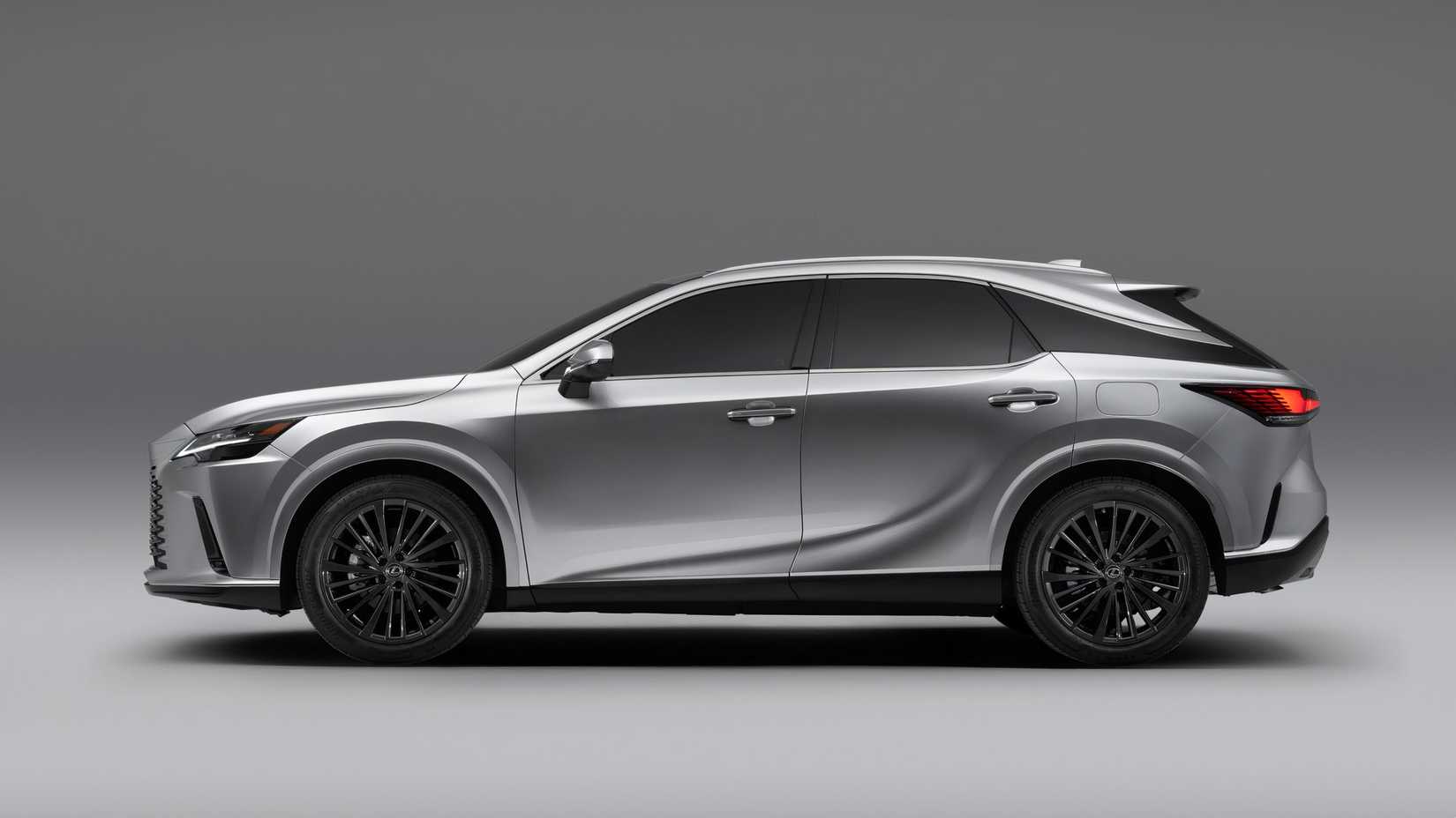 Side profile studio shot of a silver 2025 Lexus RX Hybrid