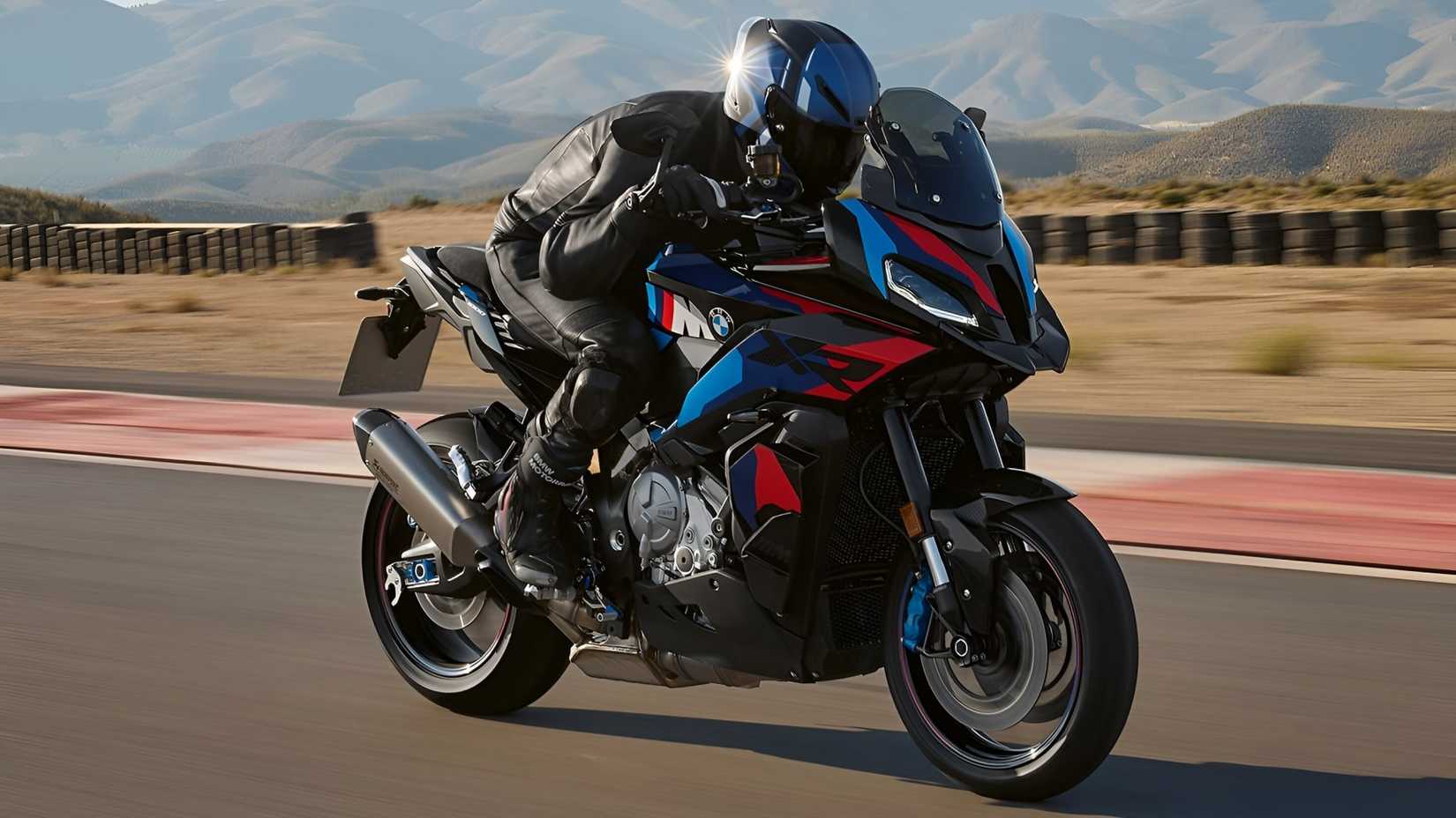 BMW M 1000 XR accelerating on a racetrack front third quarter view
