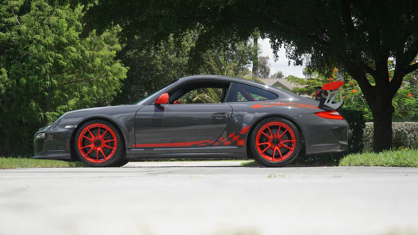 2011 Porsche 997 GT3 RS in gray and orange posing in driveway