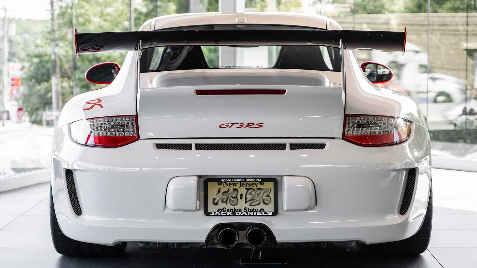 2011 Porsche 997 GT3 RS in white posing in car showroom