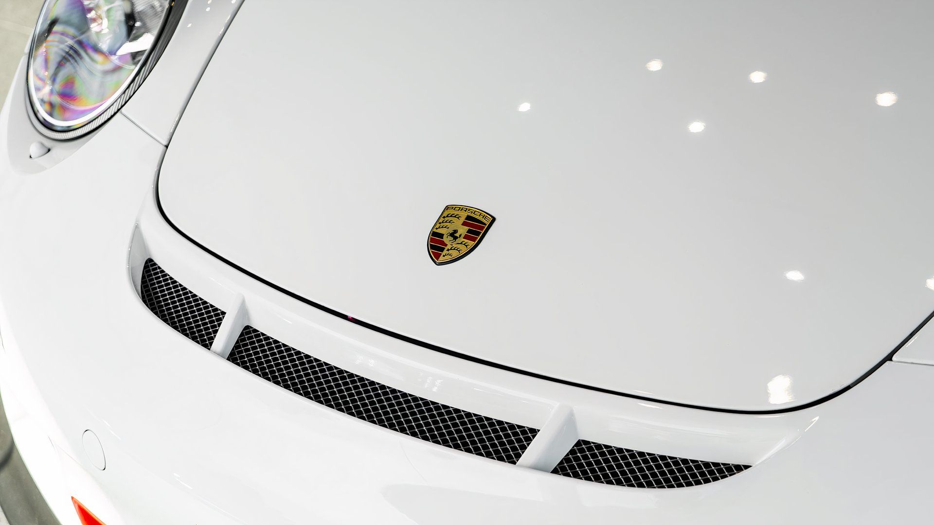 2011 Porsche 997 GT3 RS in white hood showing Porsche badge