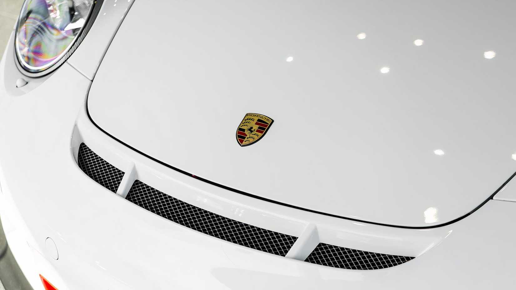 2011 Porsche 997 GT3 RS in white hood showing Porsche badge