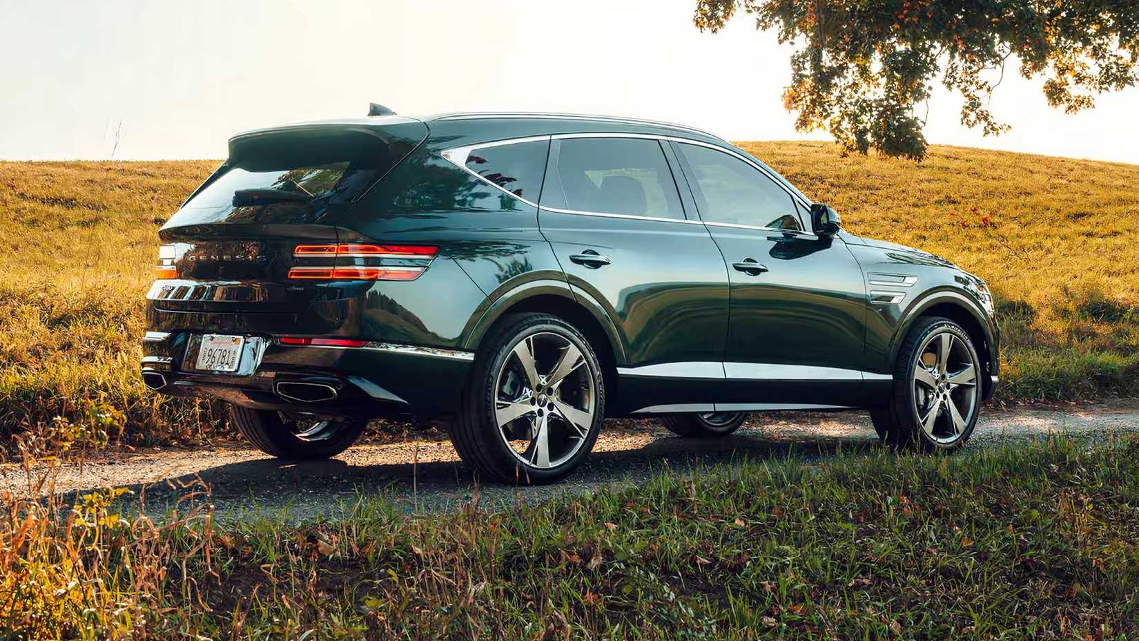2024 Genesis GV80 in green rear end posing in countryside