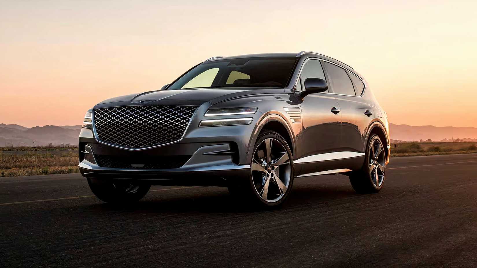 2024 Genesis GV80 in gray posing on road in desert