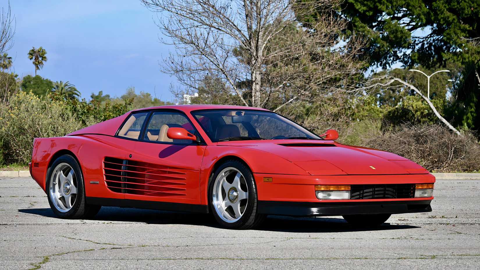 1985 Ferrari Testarossa in red posing in parking lot