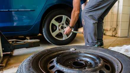 A tire shop mechanic changes a tire