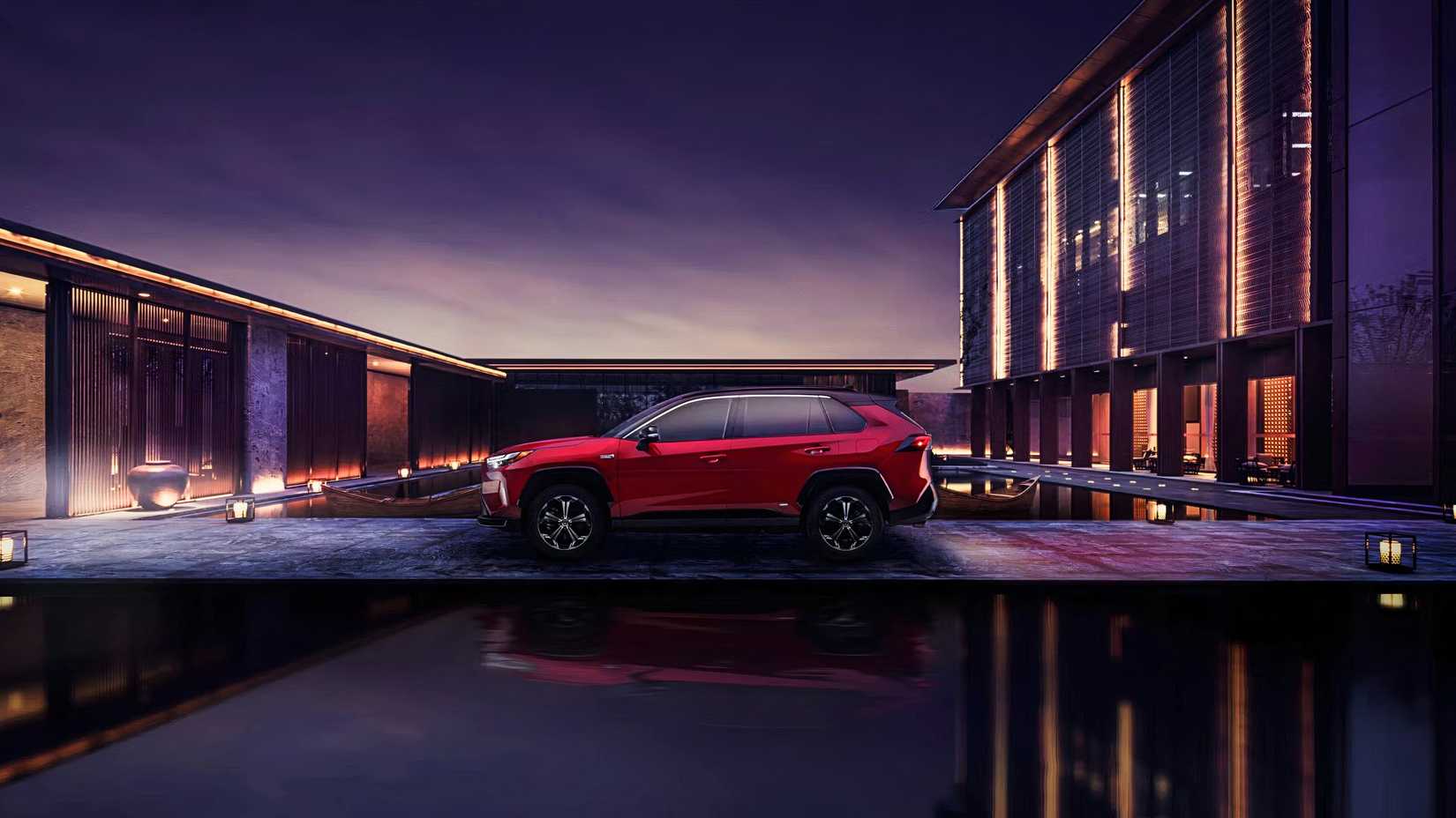A red Toyota RAV4 Prime small plug-in hybrid SUV. 