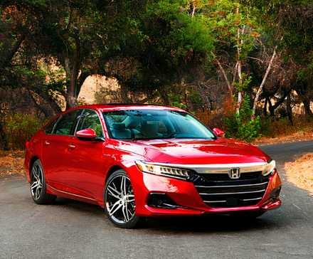 A red 2021 Honda Accord Hybrid midsize hybrid car is parked.
