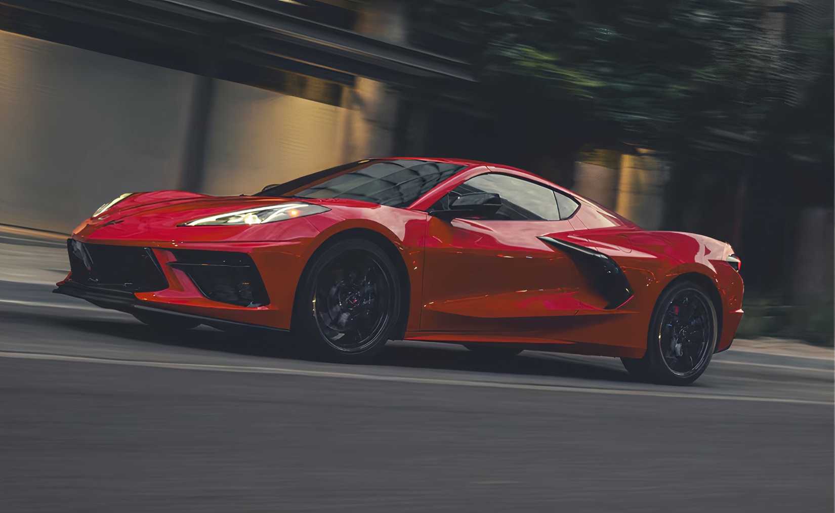 2025 Torch Red Chevrolet Corvette C8 Coupe Stingray driving on city street