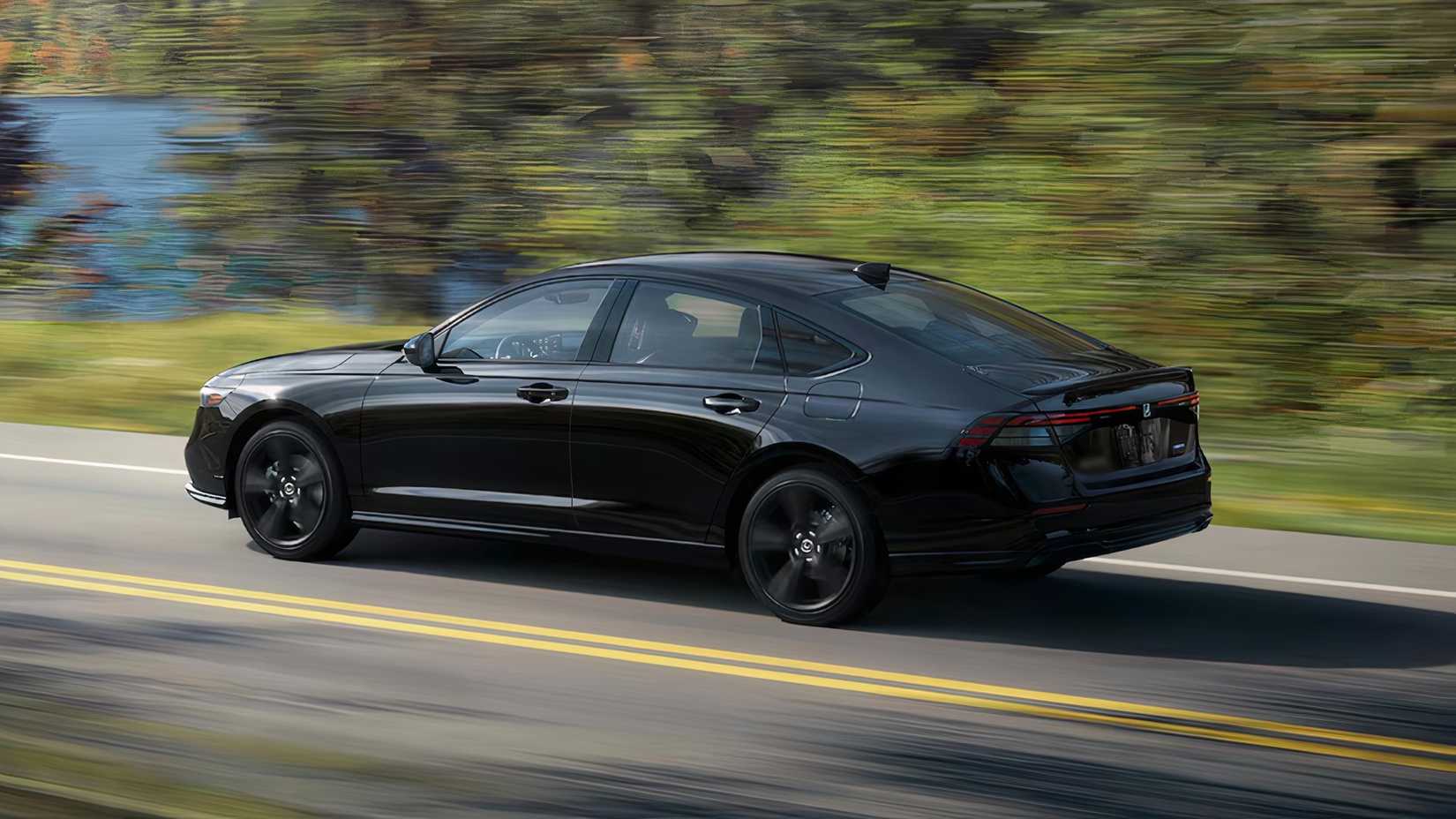Side profile action shot of a black 2025 Honda Accord Hybrid Sport-L