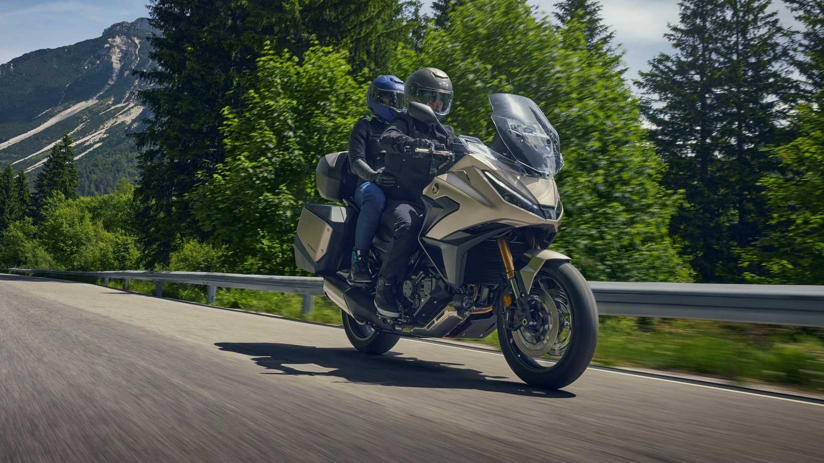 2025 Honda NT1100 cruising with pillion front third quarter view
