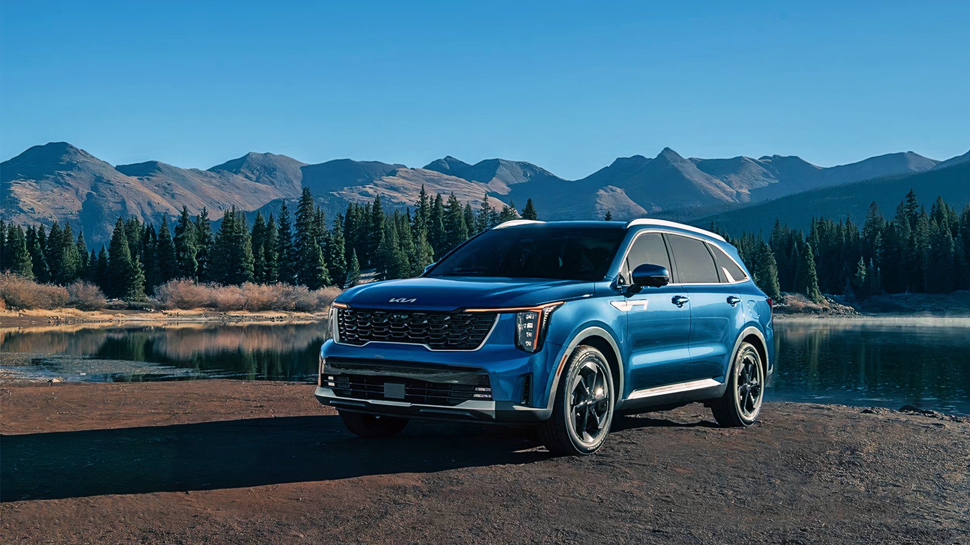 A blue 2025 Kia Sorento Hybrid midsize hybrid SUV is parked. 