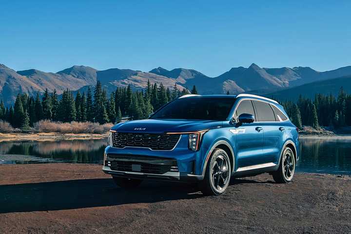 A blue 2025 Kia Sorento Hybrid midsize hybrid SUV is parked.