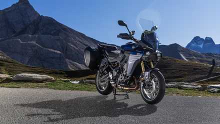 2025 Yamaha Tracer 9 GT front three quarter angle, parked on the side of the road with mountains as a backdrop