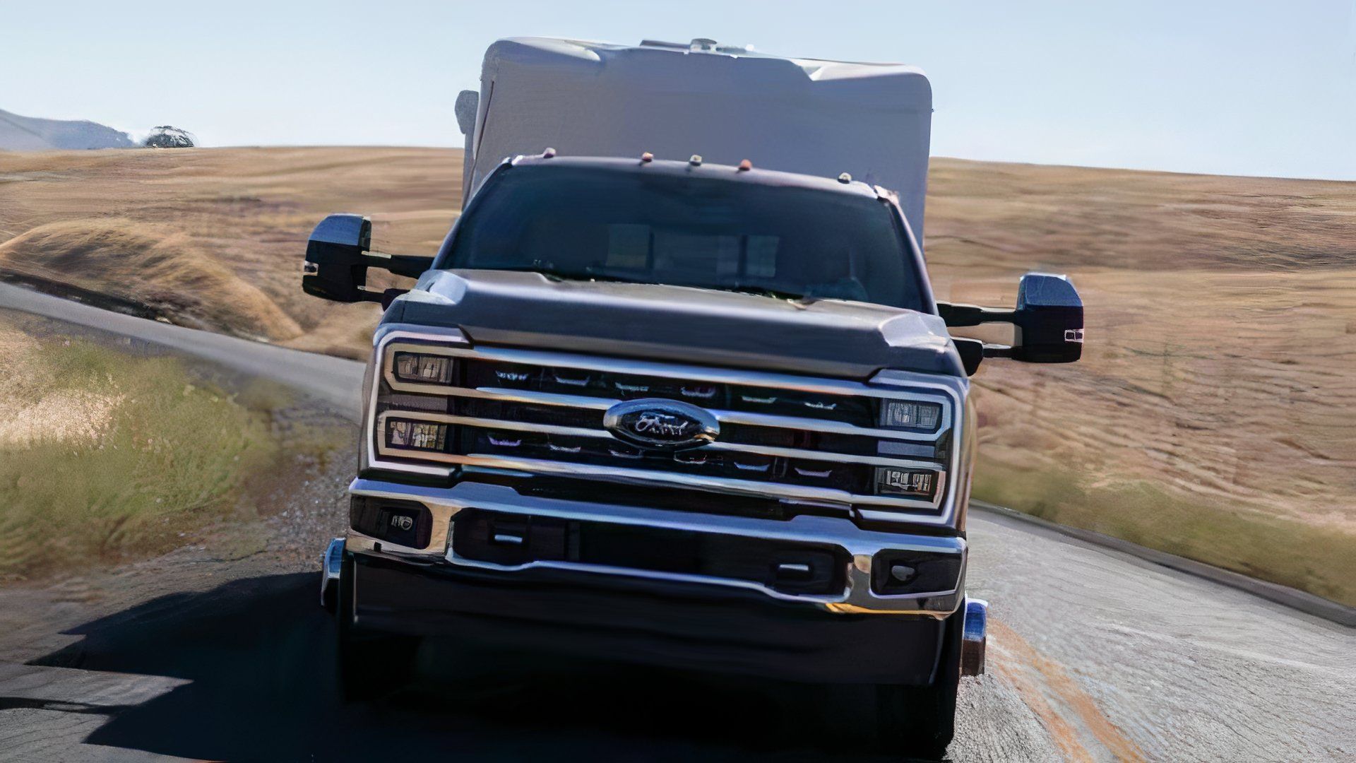 2024 Ford F-350 Super Duty LARIAT in gray towing a caravan 