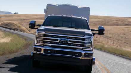 2024 Ford F-350 Super Duty LARIAT in gray towing a caravan