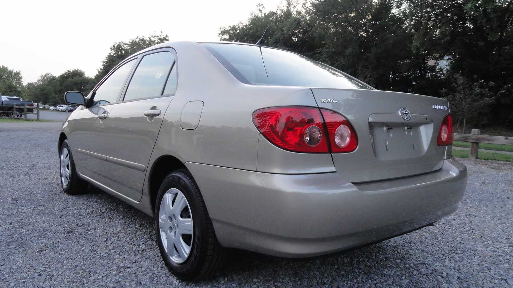 2007 Toyota Corolla LE in silver posing in parking lot