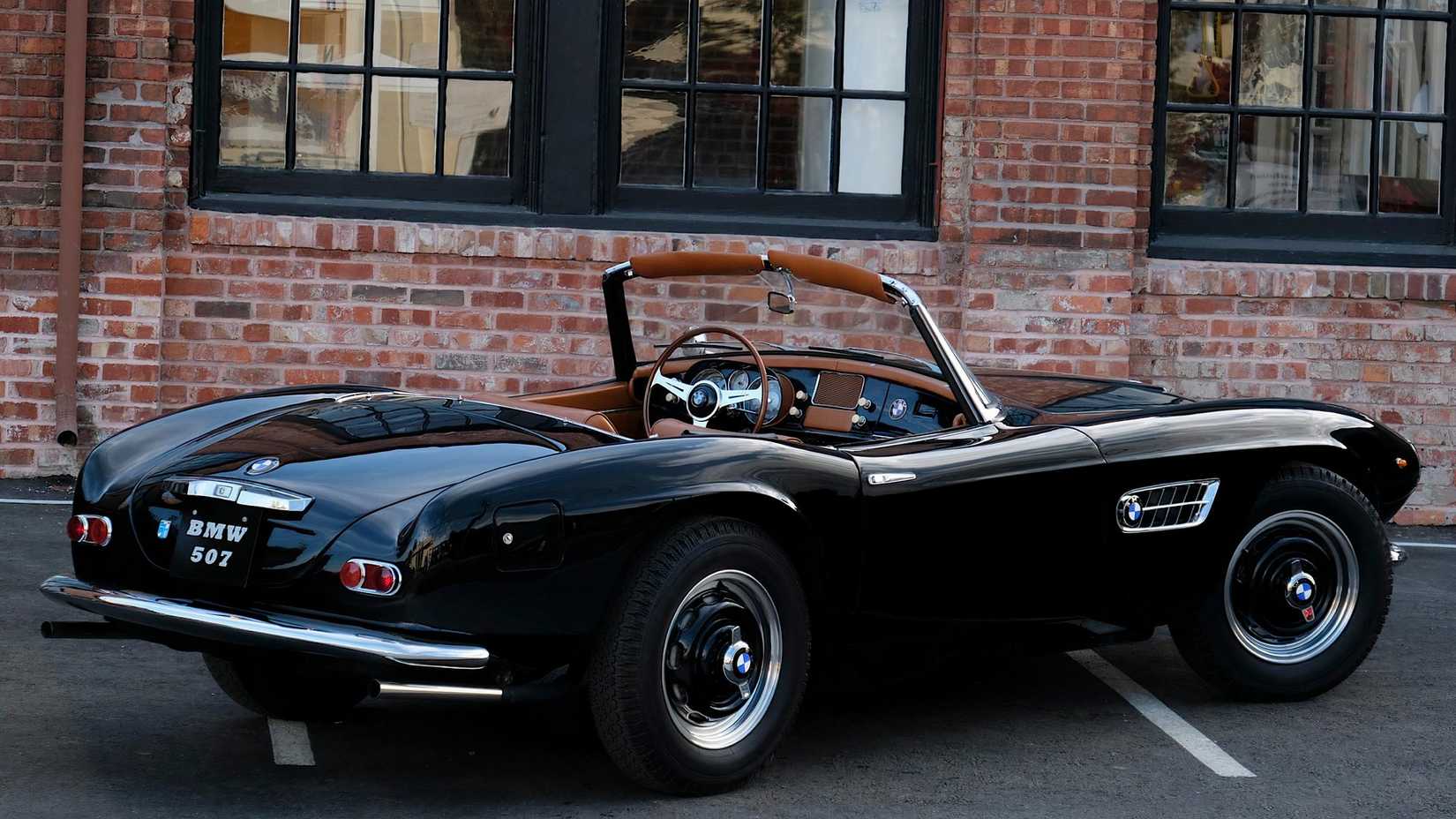 1957 BMW 507 in black with roof down posing in parking lot