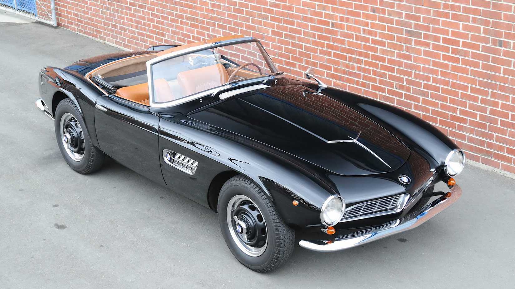 1957 BMW 507 in black posing next to a wall