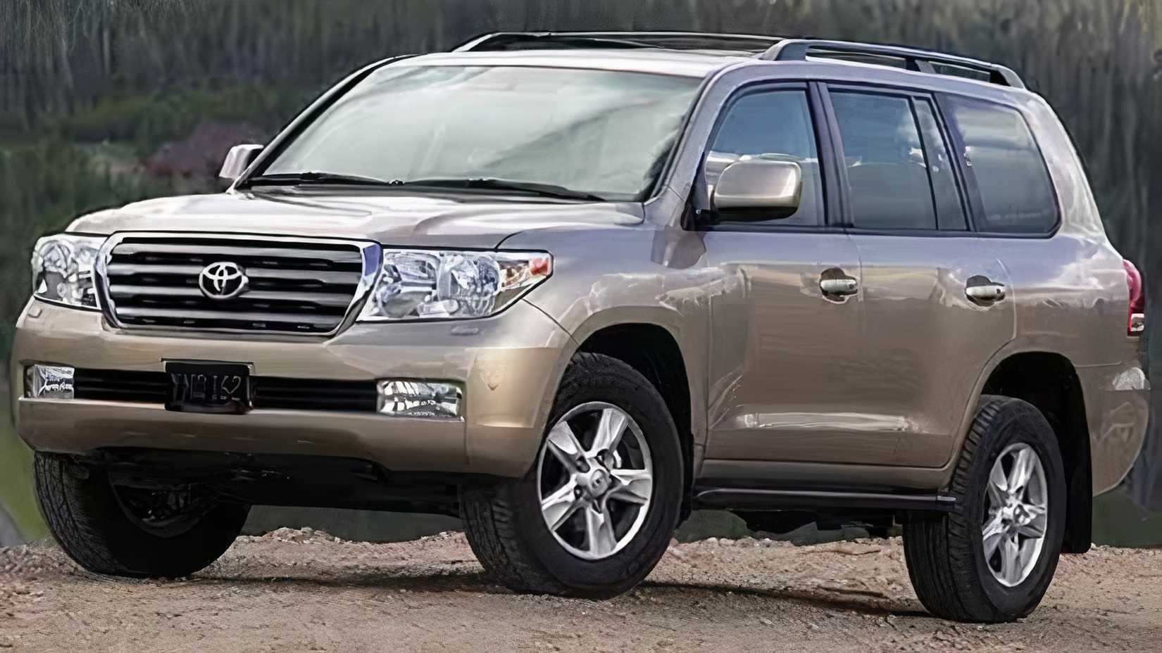 2011 Toyota Land Cruiser in gold parked