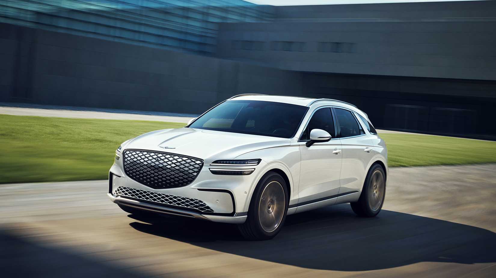 2025 Genesis GV70 in white being driven on road