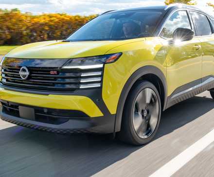 2025 Nissan Kicks SR AWD in yellow front view driving