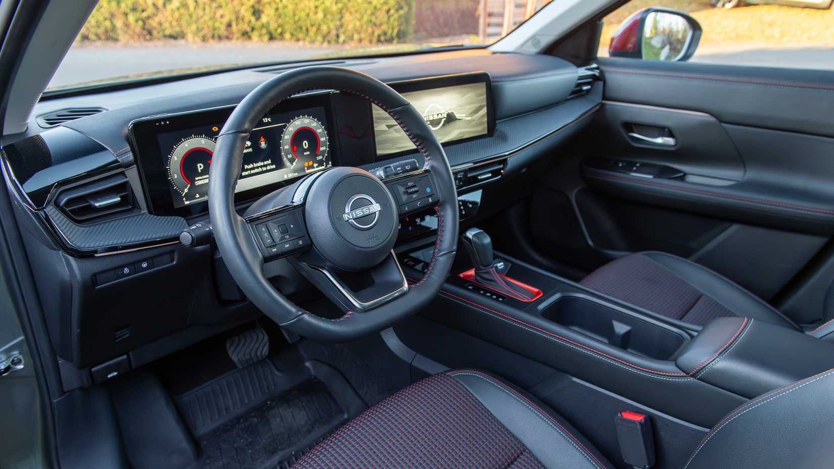 2025 Nissan Kicks SR AWD interior showing front cabin and steering wheel
